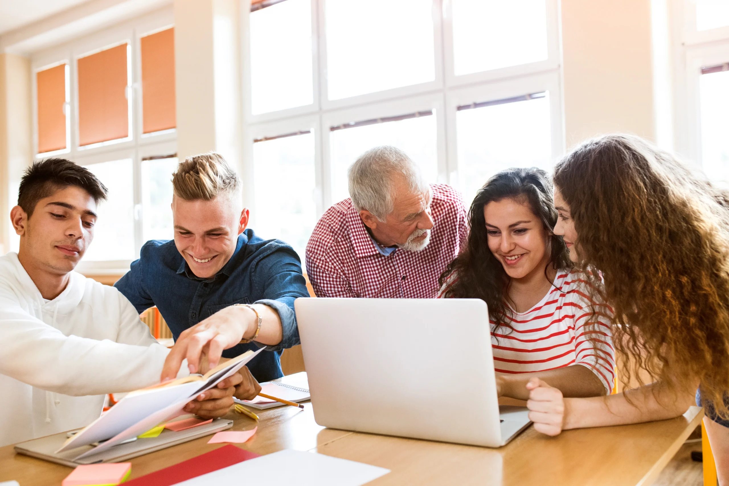 Élèves du secondaire et professeur avec ordinateur portable